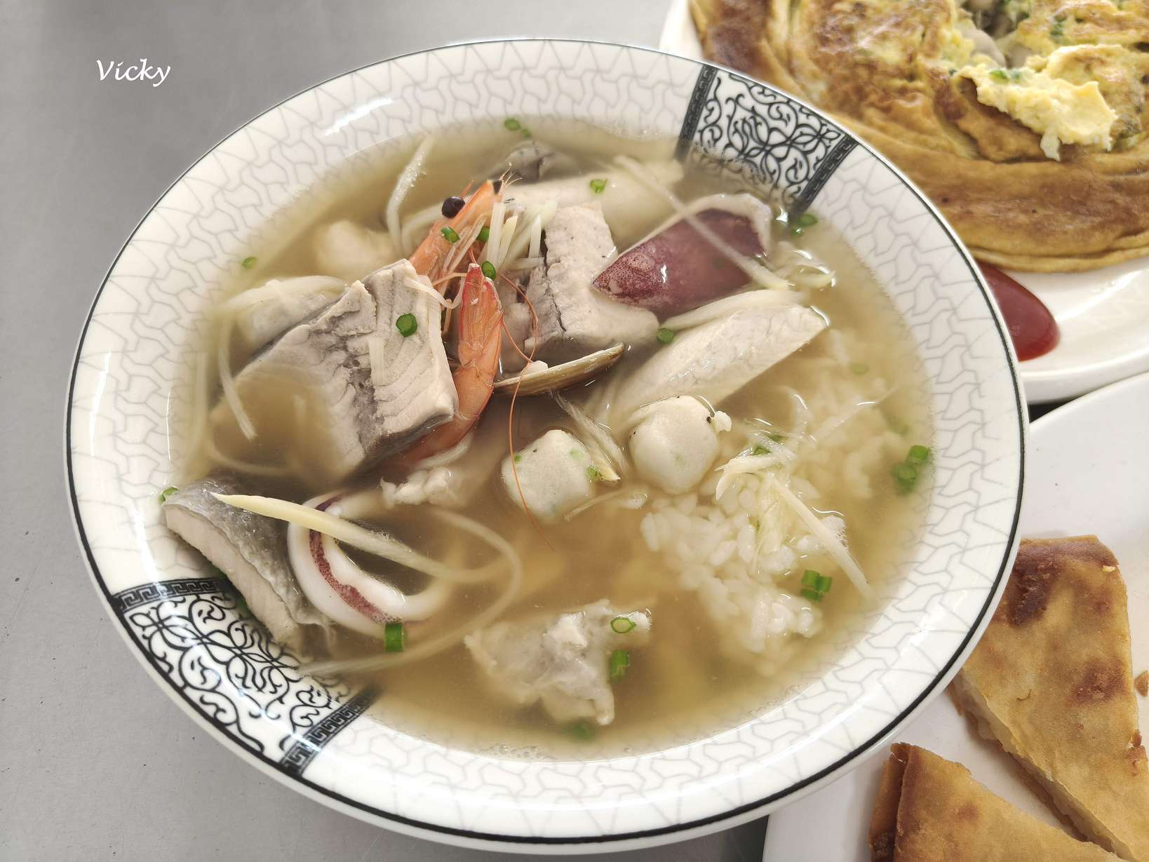 台南七股阿月虱目魚招牌海鮮粥,內含鮮蝦、蚵仔、虱目魚肉與小卷,料多實在且湯頭鮮甜。